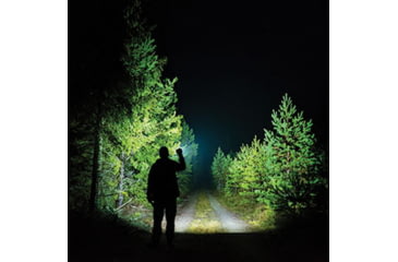 Image of man using bright flashlight outdoors