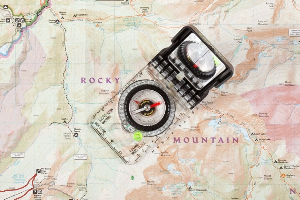 Compass on map of Rocky Mountains