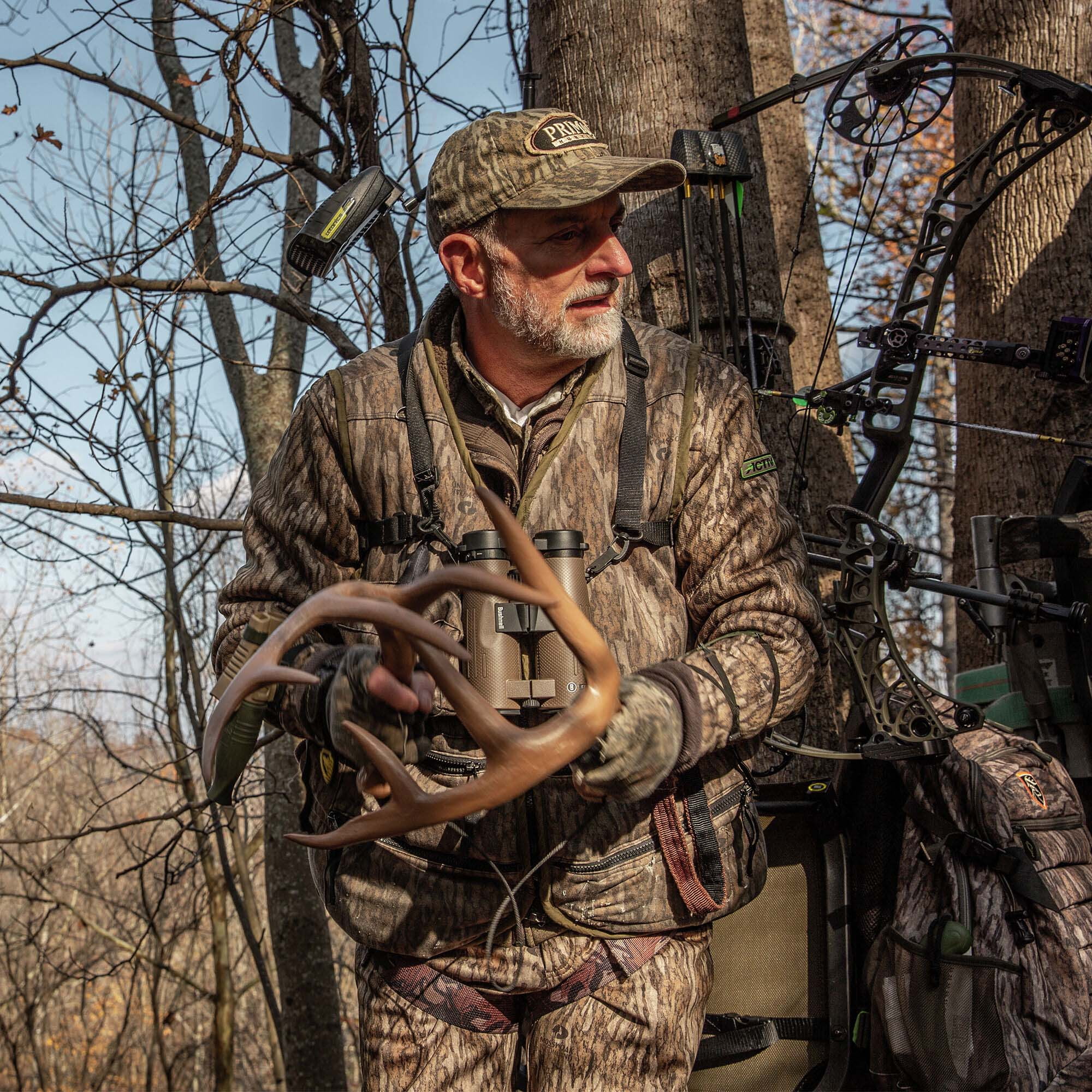 Man In Treestand Using Antler Rattle Call