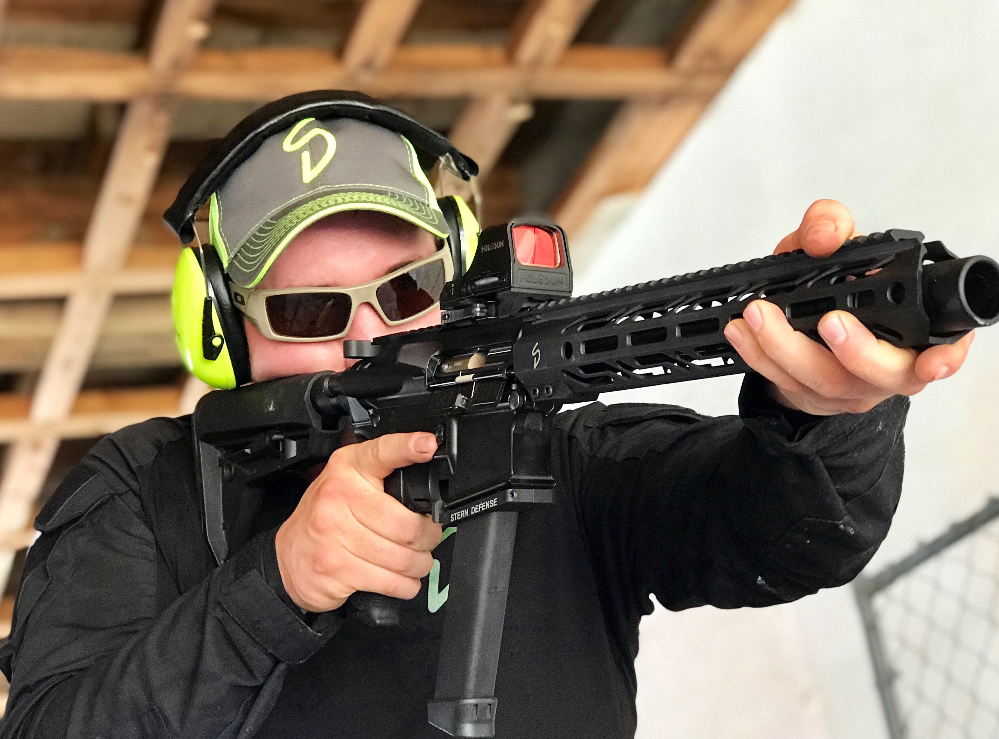 Man Shooting Stern Defense 10-Inch Assembled 9 mm Upper Receiver