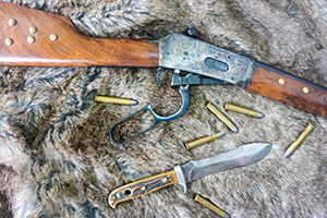 Lever action with bolt open and ammo on the ground